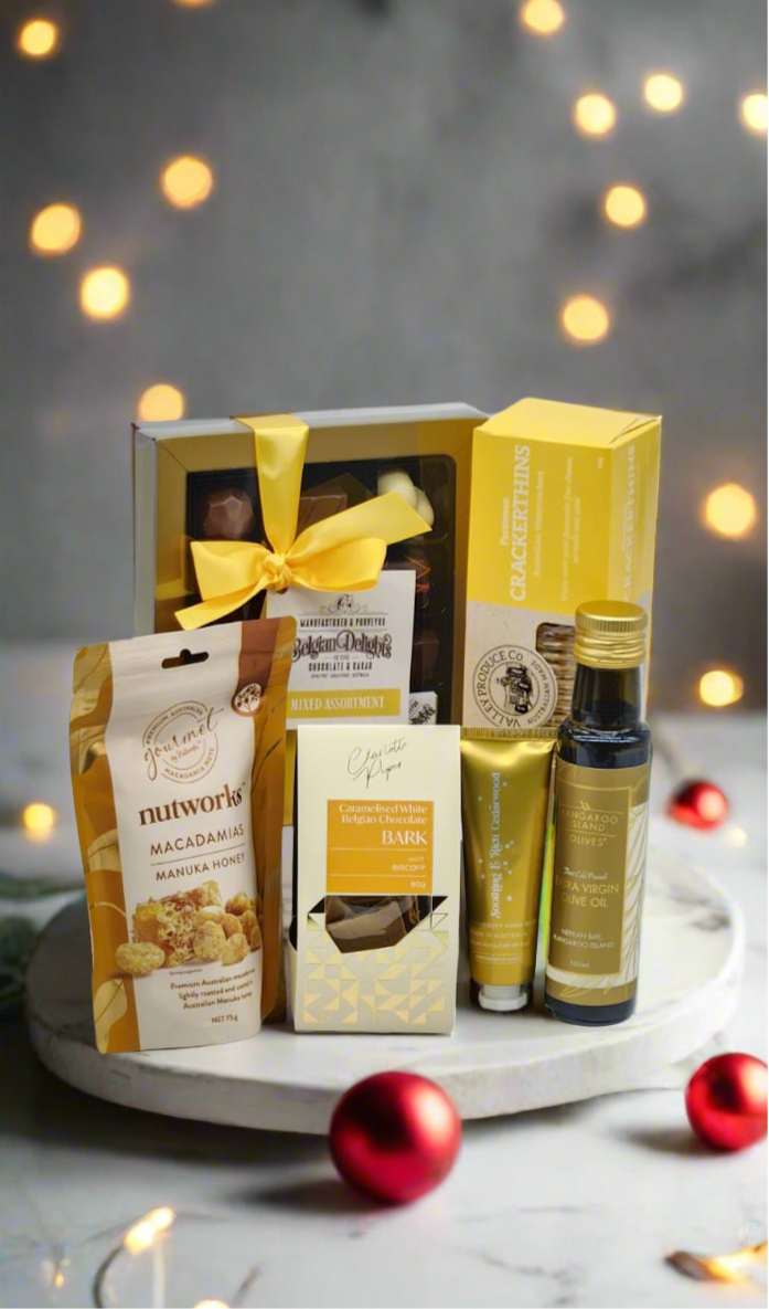 Gift basket with various items on a table with festive lights in the background